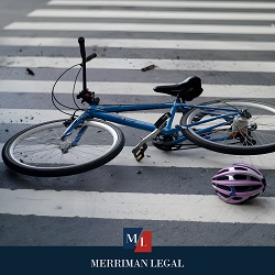 In the aftermath of a car vs. bike accident in Cleveland, a bike and helmet lay on the ground 