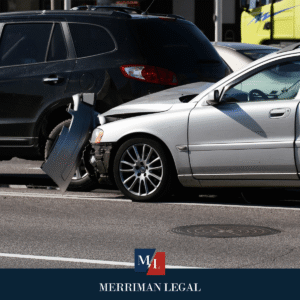 Rear-end collision between two vehicles on a city street with visible bumper and fender damage.