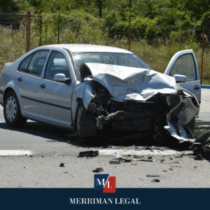 Heavily damaged sedan with crushed front end after a serious traffic accident.