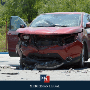 Red SUV with major front-end damage and debris on the roadway after a car crash.