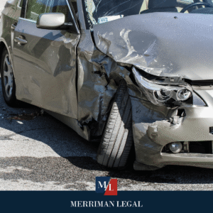 Car with heavy front-side damage and crushed door following a serious roadway collision.